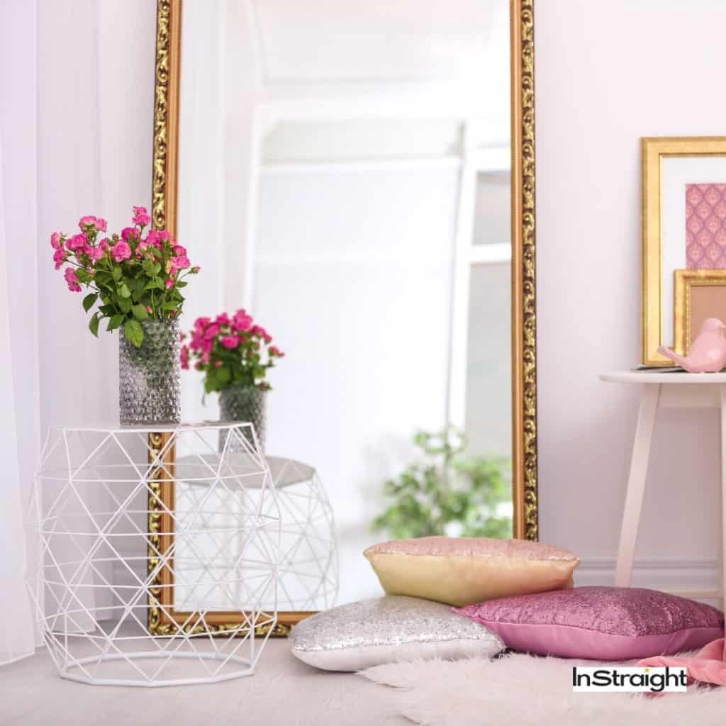 floor mirrors on next to decorative pillows under title What Type of Mirror is Used in Bathrooms